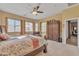 Bright main bedroom with a ceiling fan, a wardrobe, and access to the main bathroom at 9626 W Bajada Rd, Peoria, AZ 85383