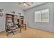 Cozy office with a built-in bookcase, a ceiling fan, and a large window at 9626 W Bajada Rd, Peoria, AZ 85383
