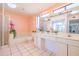 Bright bathroom features double sinks, large mirrors, and a separate shower/tub area at 11816 S Winnebago St, Phoenix, AZ 85044