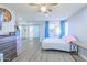 This bedroom has a ceiling fan, hard floors, and a sliding glass door that provides natural light at 11816 S Winnebago St, Phoenix, AZ 85044