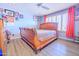 Charming bedroom showcasing wood flooring, ceiling fan, and cozy decor for a relaxing space at 11816 S Winnebago St, Phoenix, AZ 85044