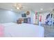 Bright bedroom boasts wood-look floors, ceiling fan, and ample storage space in the built-in shelves and closet at 11816 S Winnebago St, Phoenix, AZ 85044