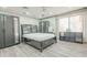 This bedroom has a ceiling fan, hard floors, and blackout blinds, providing comfort and privacy at 11816 S Winnebago St, Phoenix, AZ 85044