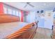 Serene bedroom showcasing natural light and wood flooring for a tranquil retreat at 11816 S Winnebago St, Phoenix, AZ 85044