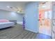 Spacious bedroom features hard flooring, ceiling fan, and an ensuite bathroom, providing comfort and convenience at 11816 S Winnebago St, Phoenix, AZ 85044