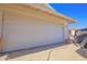 Close-up of the home's garage, featuring a well-maintained white door and clean concrete at 11816 S Winnebago St, Phoenix, AZ 85044