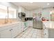 Bright kitchen featuring white cabinetry, stainless steel appliances, and a large window providing natural light at 11816 S Winnebago St, Phoenix, AZ 85044
