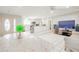 Open-concept living room flowing into kitchen, with tiled floors and ample natural light at 11816 S Winnebago St, Phoenix, AZ 85044