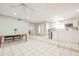 Bright, spacious living room showcasing tile flooring and an open layout leading to the kitchen at 11816 S Winnebago St, Phoenix, AZ 85044