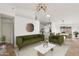 Bright, open-concept living area with modern lighting, sleek furniture, and a view to the kitchen at 12075 N 110Th St, Scottsdale, AZ 85259