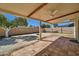 Spacious backyard featuring a covered patio, mature tree, and block fence for privacy at 1257 W Dublin St, Chandler, AZ 85224
