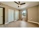 Bedroom with laminate floors, a ceiling fan, and two closets at 1257 W Dublin St, Chandler, AZ 85224