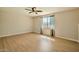 Bright bedroom with laminate floors, ceiling fan, and window with sheer curtains at 1257 W Dublin St, Chandler, AZ 85224
