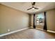 Bedroom boasting wood-look floors, ceiling fan, and arched window with curtains at 1257 W Dublin St, Chandler, AZ 85224