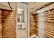 Walk-in closet featuring built-in wood shelving and access to bathroom at 1257 W Dublin St, Chandler, AZ 85224