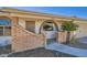 Inviting entryway with a brick facade, arched window, and well-manicured landscaping at 1257 W Dublin St, Chandler, AZ 85224