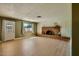 Cozy living room featuring a brick fireplace, wood-look floors, and ample natural light at 1257 W Dublin St, Chandler, AZ 85224