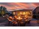 Cozy back patio with fire pit and seating, perfect for outdoor entertaining and enjoying the colorful Arizona sunset at 13068 W Mine Trl, Peoria, AZ 85383