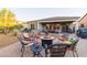 A backyard featuring a fire pit with chairs, landscaping, and a patio space for outdoor enjoyment at 13068 W Mine Trl, Peoria, AZ 85383
