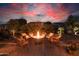 A cozy fire pit with seating in a beautifully landscaped backyard, perfect for evening gatherings at 13068 W Mine Trl, Peoria, AZ 85383