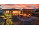 Inviting backyard with a covered patio and a fire pit seating area, perfect for evening gatherings at 13068 W Mine Trl, Peoria, AZ 85383