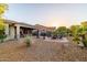 Enjoy this outdoor space with desert landscaping, a covered patio, dining area, and a fire pit lounge at 13068 W Mine Trl, Peoria, AZ 85383