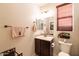Powder bathroom featuring single vanity, tile backsplash, and decorative mirror at 13068 W Mine Trl, Peoria, AZ 85383