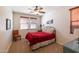 Comfortable bedroom with ceiling fan, natural light, and cowboy decor at 13068 W Mine Trl, Peoria, AZ 85383