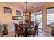 Cozy dining area with round table, decorative light fixture, and sliding glass doors to the patio at 13068 W Mine Trl, Peoria, AZ 85383