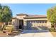Charming single-story home featuring a well-manicured yard and a two-car garage with decorative windows at 13068 W Mine Trl, Peoria, AZ 85383