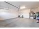 Bright, clean garage with storage, epoxy floor, and water heater providing functionality and space at 13068 W Mine Trl, Peoria, AZ 85383