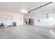 Spacious two-car garage featuring epoxy flooring, built-in storage, and ample room for vehicles and projects at 13068 W Mine Trl, Peoria, AZ 85383