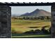 Picturesque view of the golf course framed by stone pillars and lush green fairways in the background at 13068 W Mine Trl, Peoria, AZ 85383
