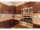 Close-up of modern kitchen area with granite countertops and stainless steel appliances for a gourmet feel at 13068 W Mine Trl, Peoria, AZ 85383