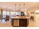 Open kitchen overlooking the Gathering room. It features bar stool seating and stainless steel dishwasher at 13068 W Mine Trl, Peoria, AZ 85383