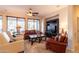 Comfortable living room featuring a ceiling fan, and large windows offering ample natural light at 13068 W Mine Trl, Peoria, AZ 85383
