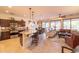 Open-concept living area boasts tile floors, ceiling fan, and a living space with a leather sofa at 13068 W Mine Trl, Peoria, AZ 85383