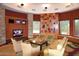 Relaxing lounge area with comfortable seating, a television and decorative wall accents at 13068 W Mine Trl, Peoria, AZ 85383