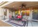 A covered patio with comfortable seating, ceiling fan, and heater creating a relaxing ambiance at 13068 W Mine Trl, Peoria, AZ 85383