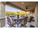 A covered patio with comfortable seating and an outdoor ceiling fan overlooking a backyard at 13068 W Mine Trl, Peoria, AZ 85383