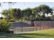 Well-maintained outdoor pickleball court with lighting, seating, and green surroundings at 13068 W Mine Trl, Peoria, AZ 85383