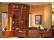 Comfortable seating area with wood bookcase and tasteful decor at 13068 W Mine Trl, Peoria, AZ 85383