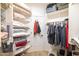 Organized walk-in closet with shelving, hanging racks, and ample storage space at 13068 W Mine Trl, Peoria, AZ 85383