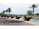 Charming entrance featuring tiered water features, manicured landscaping, and towering palm trees at 13068 W Mine Trl, Peoria, AZ 85383