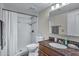 This bathroom features a shower with updated fixture, granite countertops, and a large mirror at 14145 N 92Nd St # 2046, Scottsdale, AZ 85260