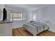 Bright bedroom with natural light, wood floors, and a cozy bed at 14145 N 92Nd St # 2046, Scottsdale, AZ 85260