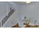 Dining area with a glass table and white chairs, located near the staircase at 14145 N 92Nd St # 2046, Scottsdale, AZ 85260