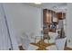 Cozy dining area with a glass table and four white chairs, adjacent to kitchen area at 14145 N 92Nd St # 2046, Scottsdale, AZ 85260