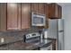 Modern kitchen with stainless steel appliances, granite countertops, and ample storage at 14145 N 92Nd St # 2046, Scottsdale, AZ 85260