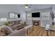 Bright living room featuring a cozy fireplace, TV, ceiling fan, and comfortable seating arrangement at 14145 N 92Nd St # 2046, Scottsdale, AZ 85260